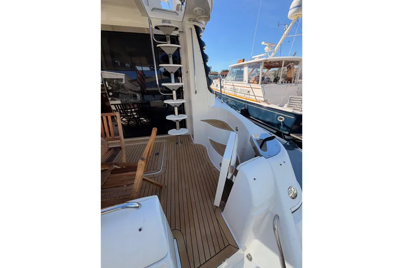 Le Reve Yacht Photos Pics 1999 Carver 530 Voyager Pilothouse yacht deck with wooden flooring and spiral staircase.