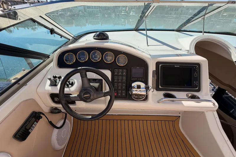 Le Reve Yacht Photos Pics 1999 Carver 530 Voyager Pilothouse helm with steering wheel and navigation instruments.