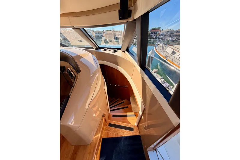 Le Reve Yacht Photos Pics Interior view of 1999 Carver 530 Voyager Pilothouse with wooden stairs and large windows.