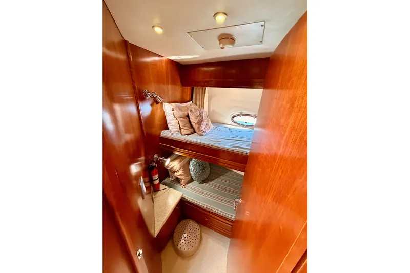 Le Reve Yacht Photos Pics Cozy cabin interior of 1999 Carver 530 Voyager Pilothouse with bunk beds and wooden finish.