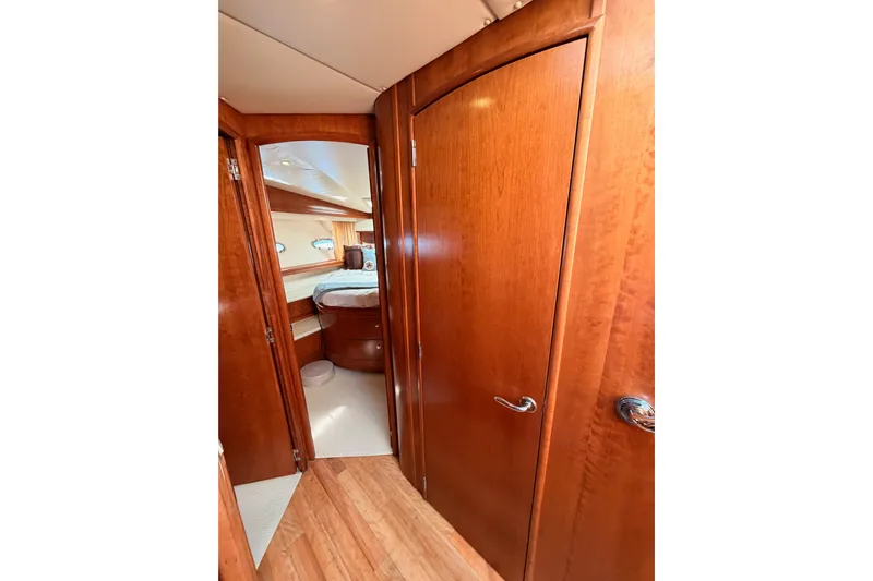 Le Reve Yacht Photos Pics Interior of 1999 Carver 530 Voyager Pilothouse with wooden doors and cozy bedroom.