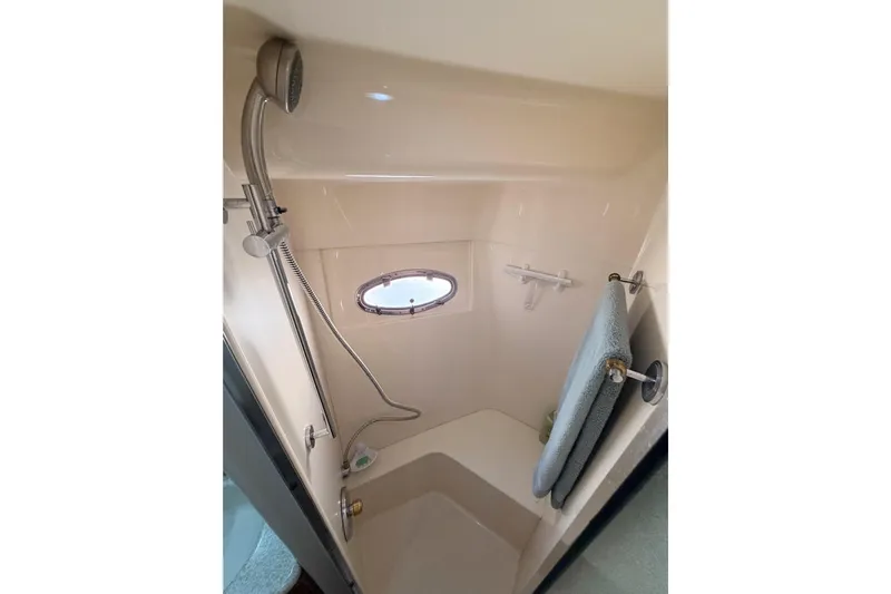 Le Reve Yacht Photos Pics Shower area in 1999 Carver 530 Voyager Pilothouse with porthole and towel rack.