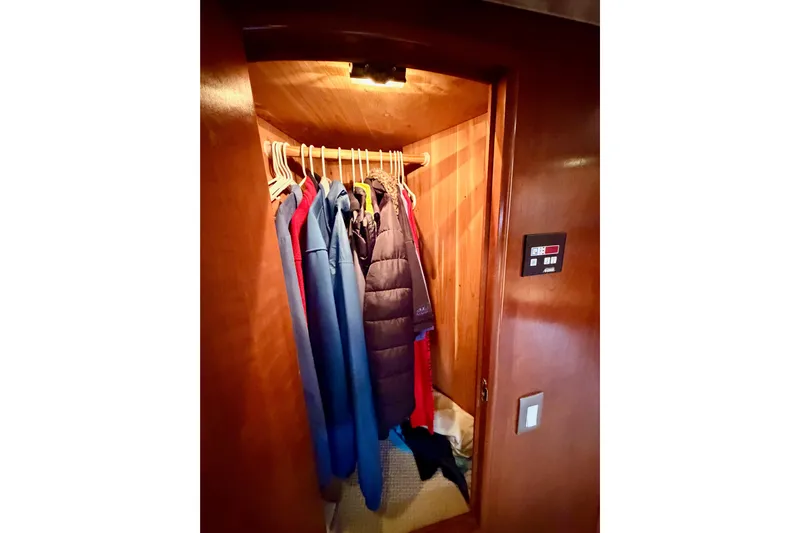 Le Reve Yacht Photos Pics Closet inside 1999 Carver 530 Voyager Pilothouse with hanging jackets and coats.