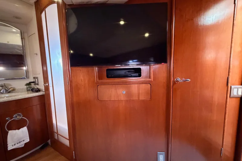 Le Reve Yacht Photos Pics Interior of 1999 Carver 530 Voyager Pilothouse with TV and wooden cabinetry.