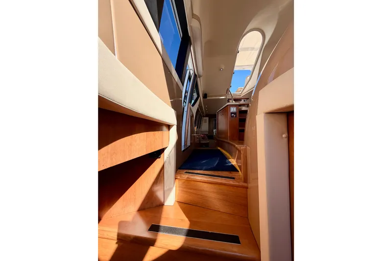 Le Reve Yacht Photos Pics Interior view of 1999 Carver 530 Voyager Pilothouse with wooden steps and modern design.