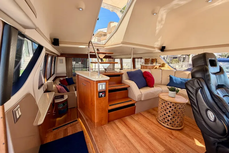 Le Reve Yacht Photos Pics Luxurious interior of 1999 Carver 530 Voyager Pilothouse with plush seating and elegant wood finishes.