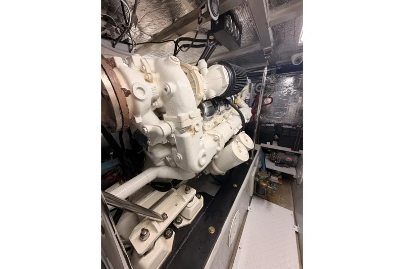 Le Reve Yacht Photos Pics Engine room of 1999 Carver 530 Voyager Pilothouse with white machinery and metallic surroundings.