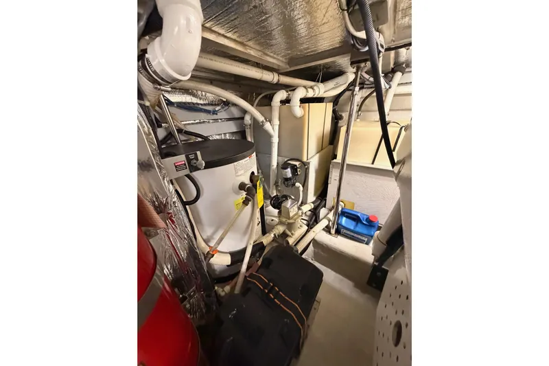 Le Reve Yacht Photos Pics Engine room of 1999 Carver 530 Voyager Pilothouse with mechanical equipment and piping.