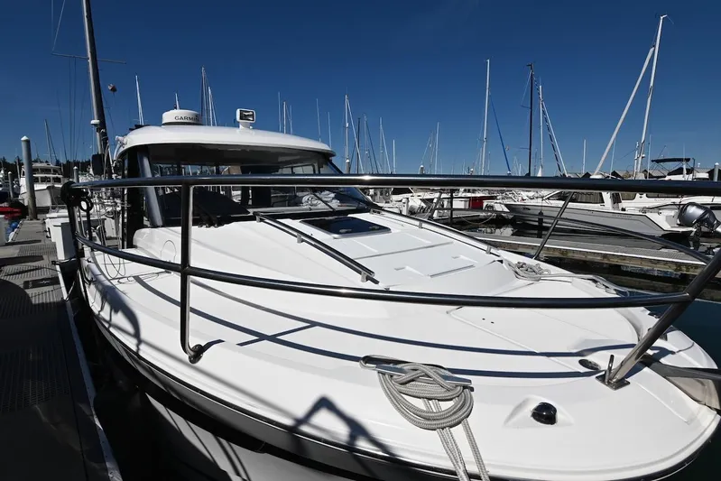 Shantytown Yacht Photos Pics 2020 Jeanneau NC 895 boat docked at marina, surrounded by sailboats under clear blue sky.