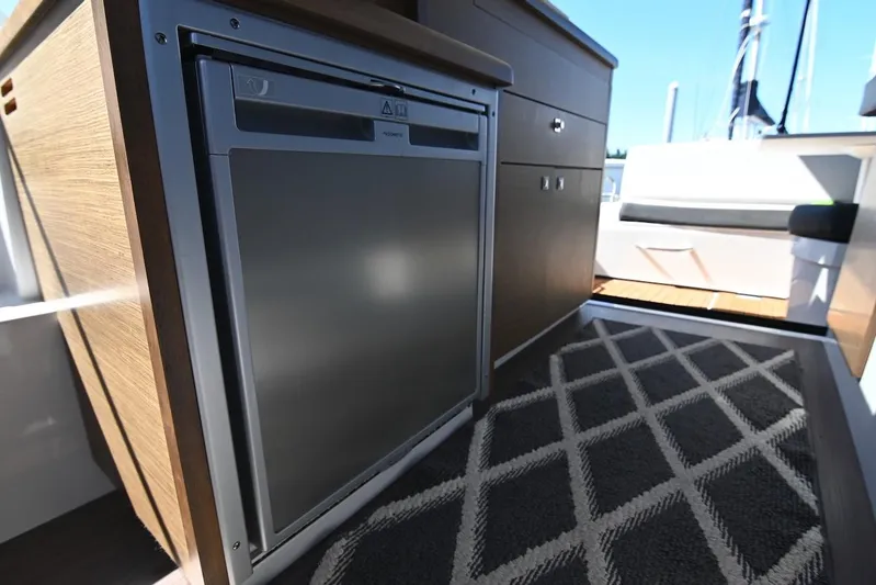 Shantytown Yacht Photos Pics Interior of 2020 Jeanneau NC 895 boat showing compact kitchen area with fridge.