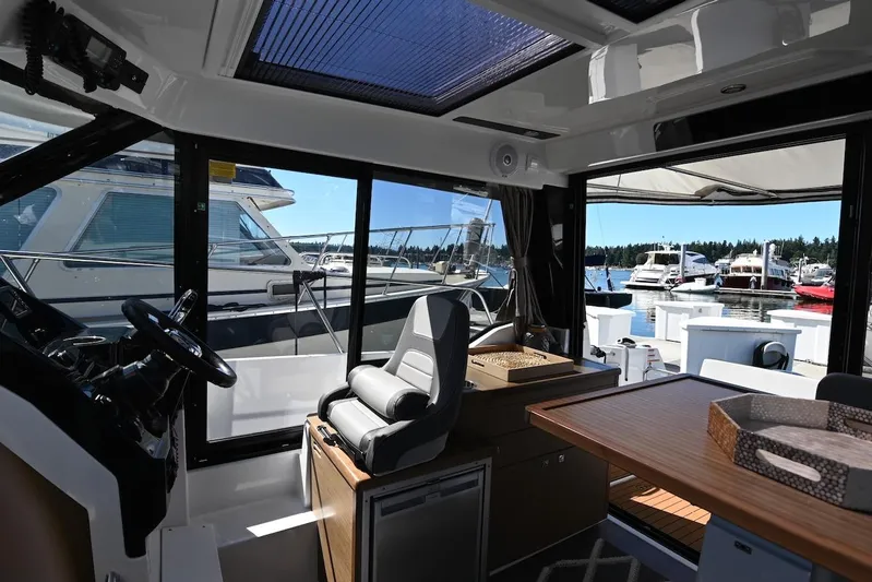 Shantytown Yacht Photos Pics Interior of 2020 Jeanneau NC 895 boat with marina view through large windows.