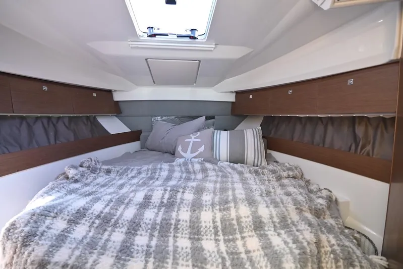 Shantytown Yacht Photos Pics Cozy cabin interior of 2020 Jeanneau NC 895 with plush bedding and nautical decor.