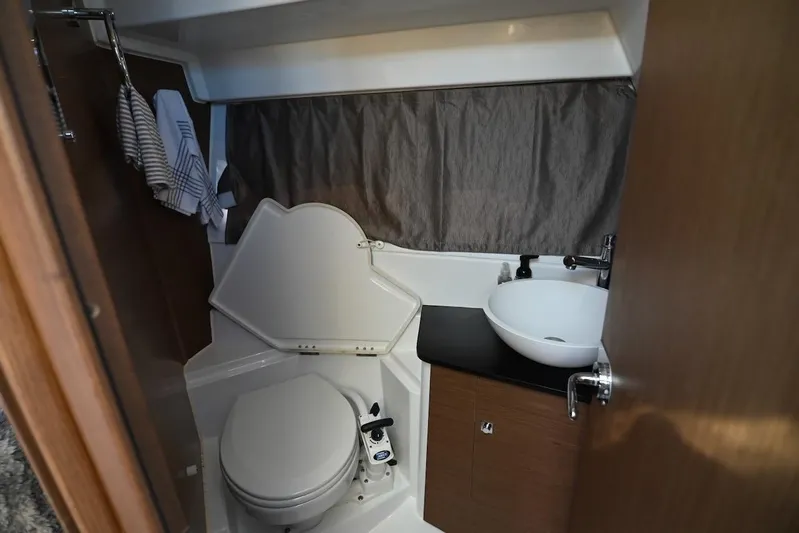 Shantytown Yacht Photos Pics 2020 Jeanneau NC 895 boat bathroom with toilet, sink, and storage cabinet.