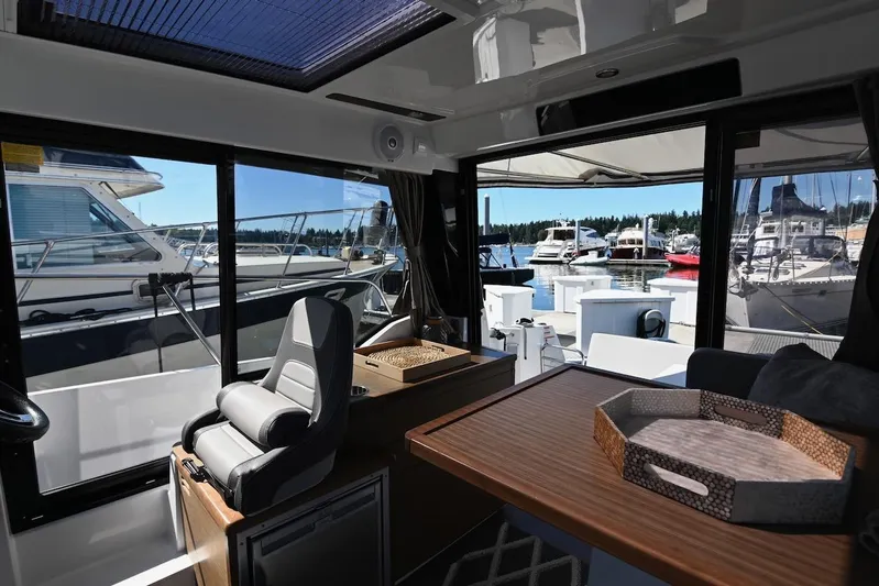 Shantytown Yacht Photos Pics Interior of 2020 Jeanneau NC 895 boat with marina view through large windows.