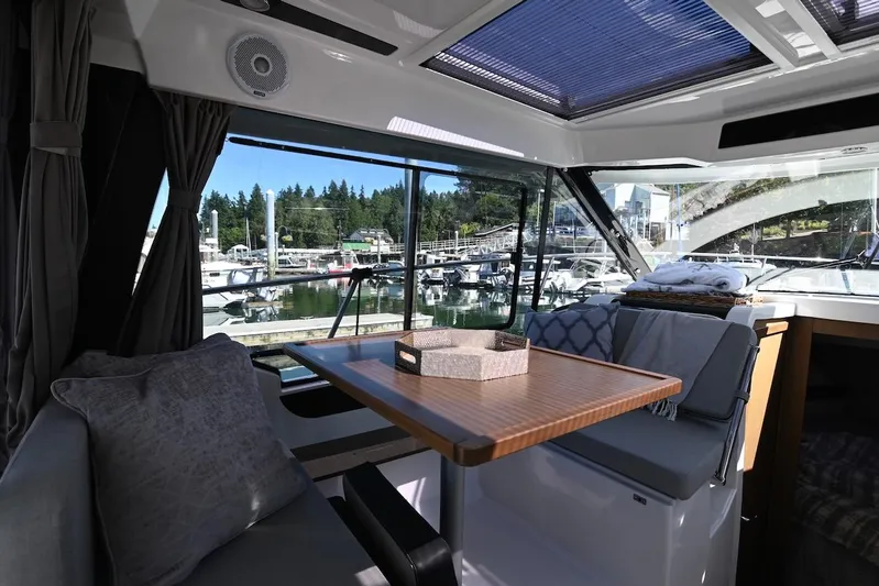 Shantytown Yacht Photos Pics Interior of 2020 Jeanneau NC 895 boat with marina view through large windows.