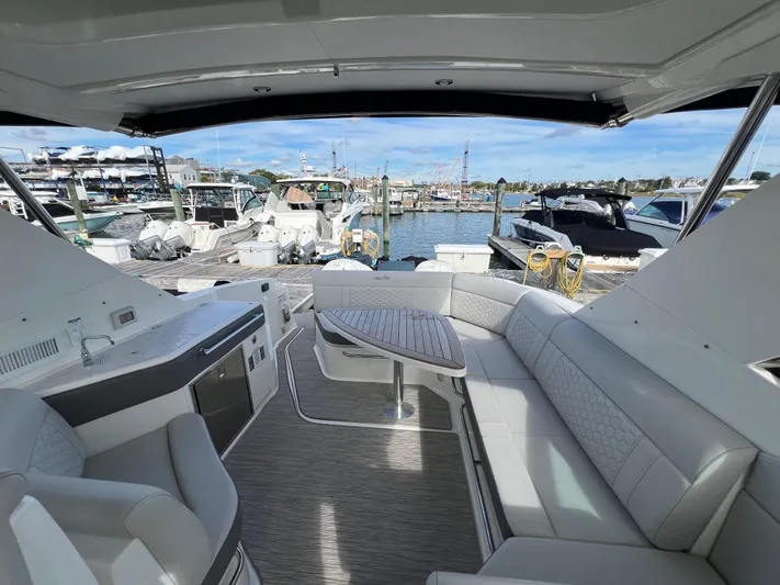 Touch Of Grey Yacht Photos Pics 2022 Sea Ray Sundancer 320 OB interior with spacious seating and marina view.