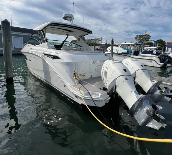 Touch Of Grey Yacht Photos Pics 2022 Sea Ray Sundancer 320 OB docked with twin outboard engines.