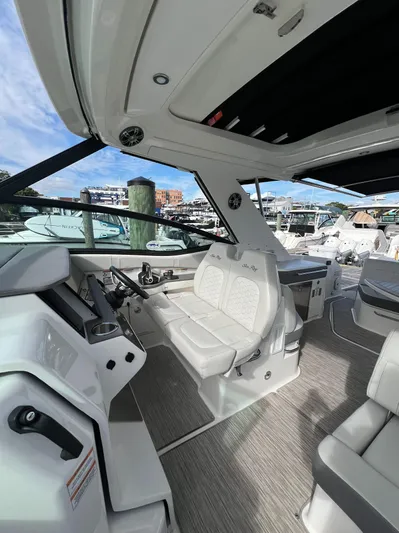 Touch Of Grey Yacht Photos Pics 2022 Sea Ray Sundancer 320 OB interior with modern seating and dashboard, docked at marina.