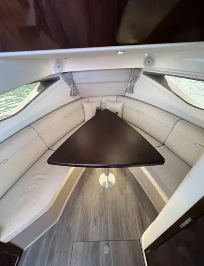 Touch Of Grey Yacht Photos Pics 2022 Sea Ray Sundancer 320 OB cabin with elegant seating and triangular table.