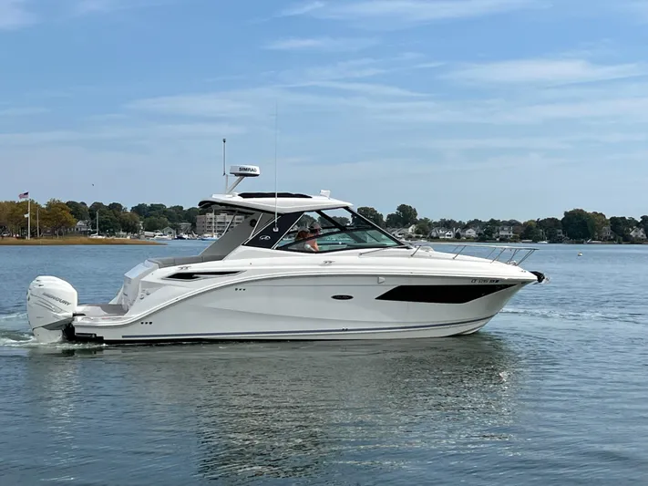 Touch Of Grey Yacht Photos Pics 2022 Sea Ray Sundancer 320 OB cruising on calm waters.