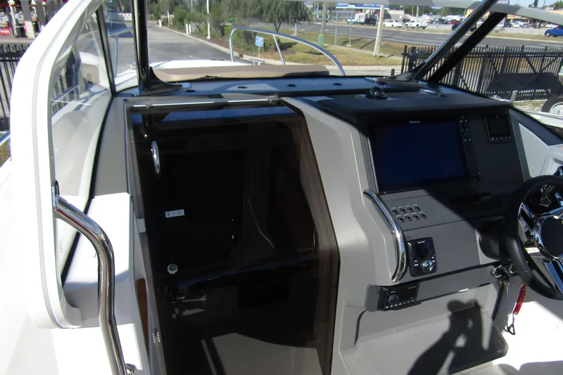  Yacht Photos Pics Interior view of 2025 Nimbus Tender 9 boat cockpit with modern controls and steering wheel.