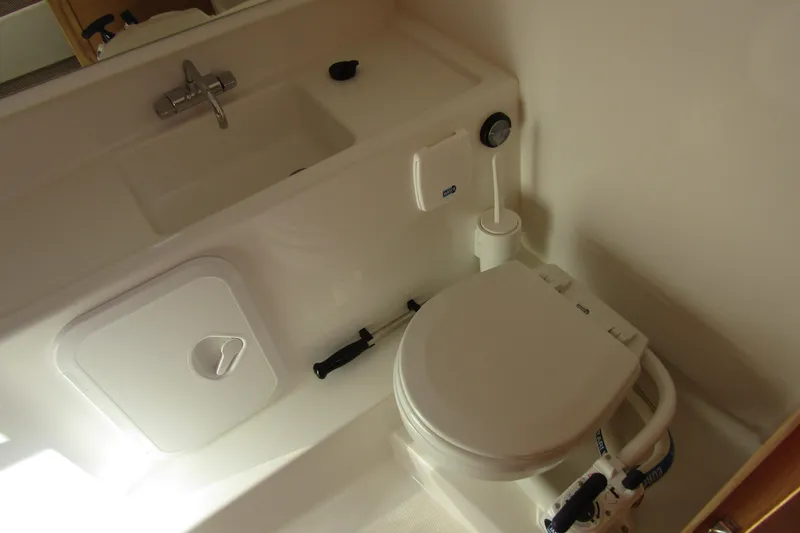  Yacht Photos Pics Compact bathroom in 2025 Nimbus Tender 9 boat with sink and toilet.