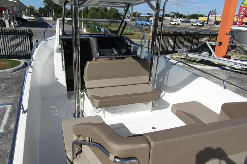  Yacht Photos Pics 2025 Nimbus Tender 9 boat interior with beige seating and modern dashboard.
