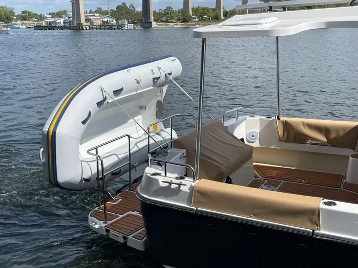  Yacht Photos Pics 2025 Ranger Tugs R-31S boat with an attached inflatable dinghy on the water.