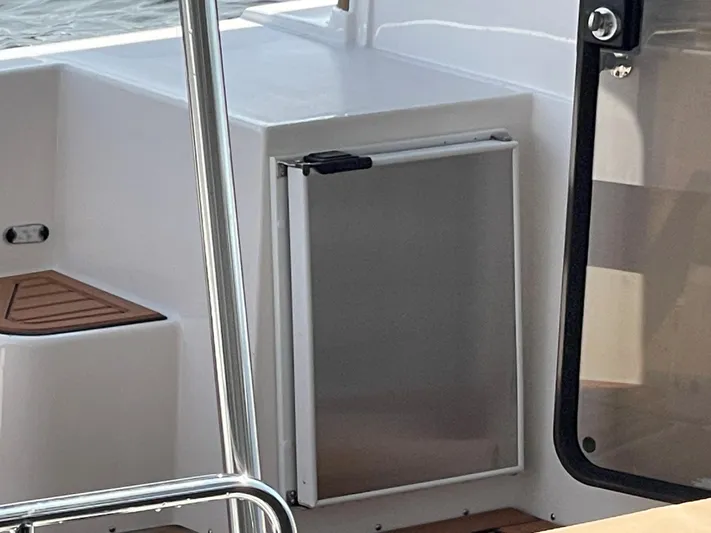  Yacht Photos Pics Ranger Tugs R-31S 2025 boat interior with a small refrigerator and seating area.