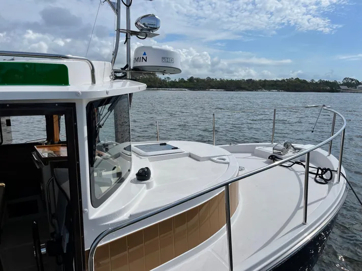  Yacht Photos Pics 2025 Ranger Tugs R-31S boat on calm water with clear sky.