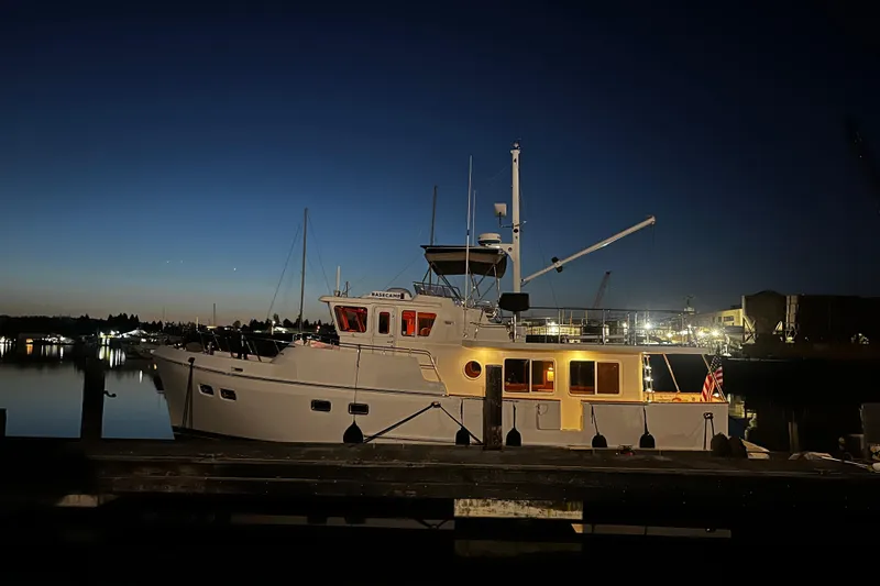 Basecamp Yacht Photos Pics Selene 47 yacht docked at night, illuminated against a twilight sky, 2003 model.