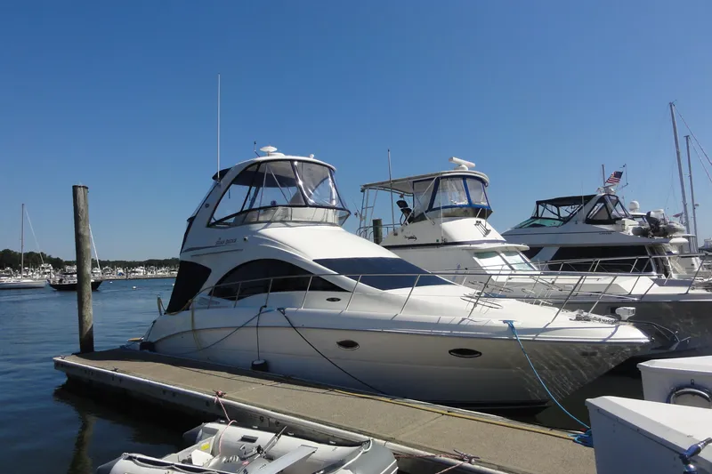  Yacht Photos Pics 2007 Sea Ray 36 Sedan Bridge yacht docked at marina under clear blue sky.