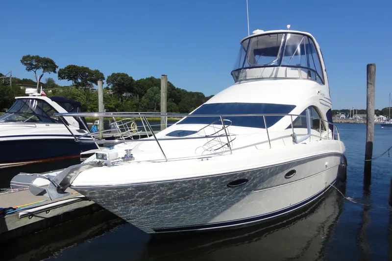  Yacht Photos Pics 2007 Sea Ray 36 Sedan Bridge yacht docked in a marina under clear blue skies.