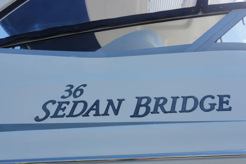  Yacht Photos Pics 2007 Sea Ray 36 Sedan Bridge boat nameplate in close-up view.