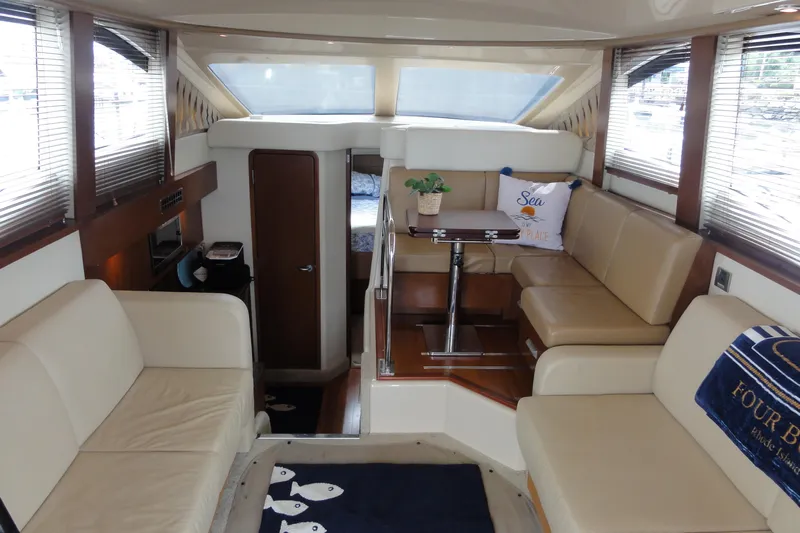  Yacht Photos Pics Interior of 2007 Sea Ray 36 Sedan Bridge yacht with beige seating and dining area.