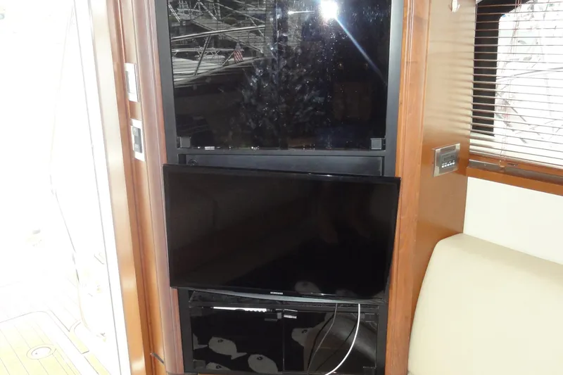  Yacht Photos Pics Interior of 2007 Sea Ray 36 Sedan Bridge with mounted TV and wooden paneling.