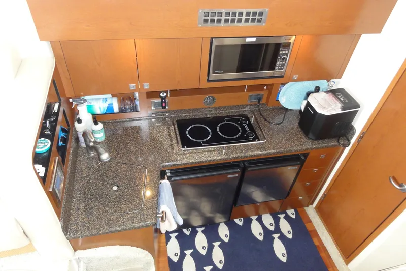  Yacht Photos Pics 2007 Sea Ray 36 Sedan Bridge galley with granite countertops, stove, microwave, and compact appliances.