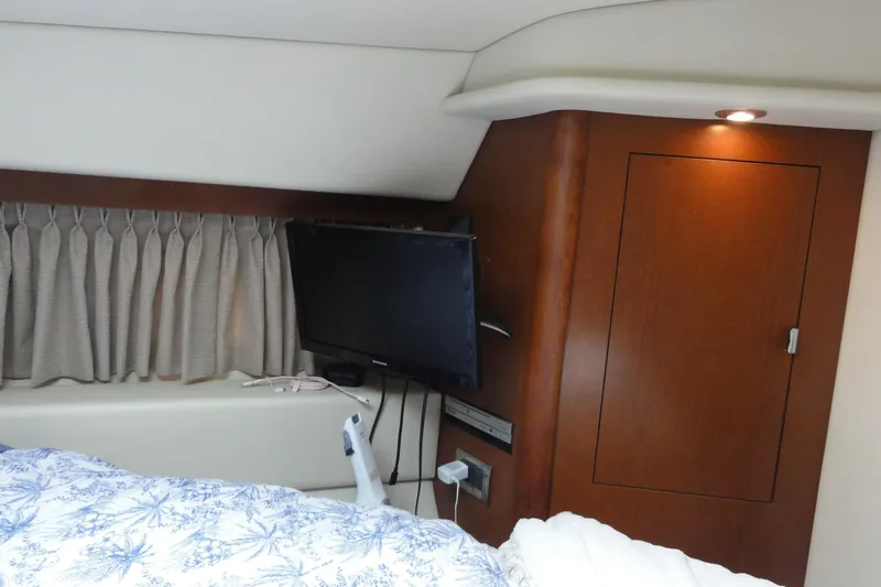  Yacht Photos Pics Interior cabin of 2007 Sea Ray 36 Sedan Bridge with TV and wooden cabinetry.