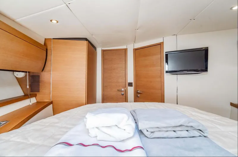 Parea Yacht Photos Pics Luxurious interior of 2011 Azimut Atlantis 40 yacht with cozy bedding and modern amenities.