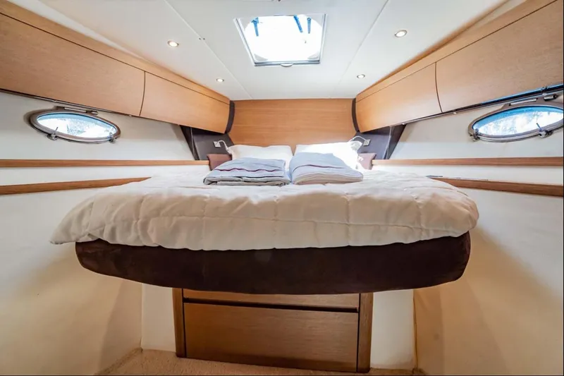Parea Yacht Photos Pics Luxurious cabin interior of 2011 Azimut Atlantis 40 yacht with cozy bed and porthole windows.