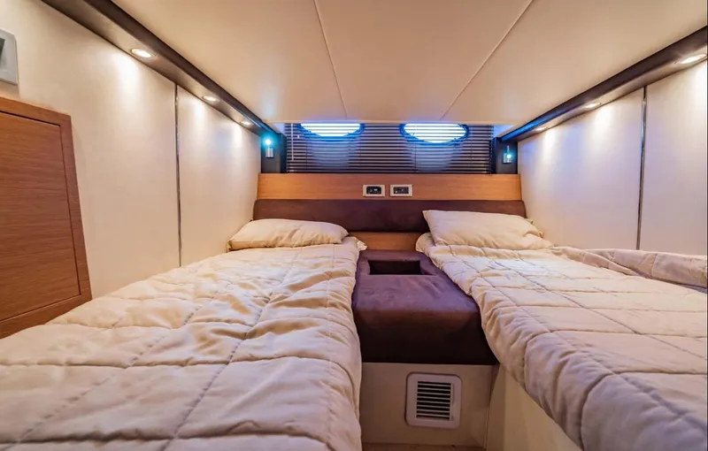 Parea Yacht Photos Pics Luxurious twin cabin interior of 2011 Azimut Atlantis 40 yacht, featuring cozy bedding and ambient lighting.