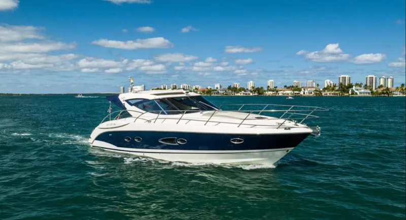 Parea Yacht Photos Pics Azimut Atlantis 40 yacht cruising on blue waters, city skyline in background, 2011 model.