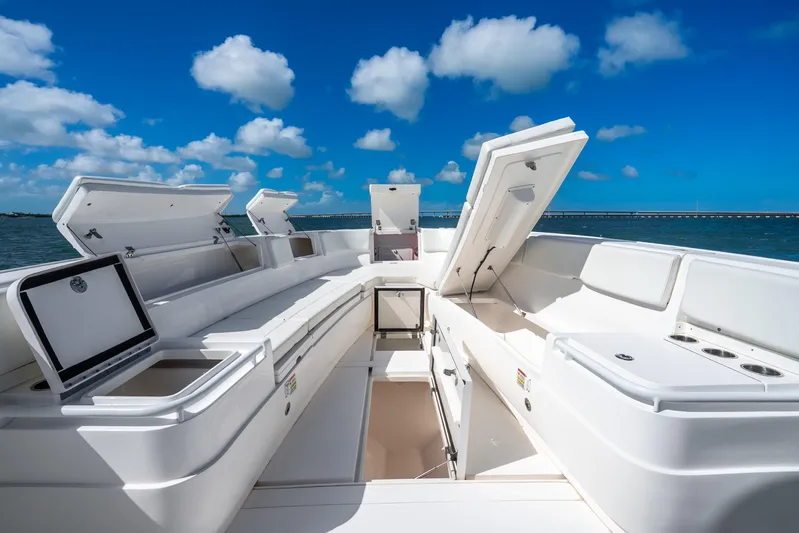  Yacht Photos Pics 2016 Intrepid 400 Center Console boat with open storage compartments, under a clear blue sky.