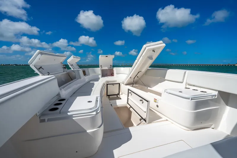  Yacht Photos Pics 2016 Intrepid 400 Center Console boat with open storage compartments, under a clear blue sky.