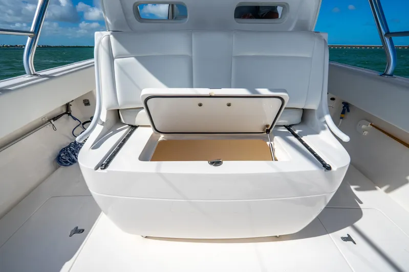  Yacht Photos Pics 2016 Intrepid 400 Center Console boat with open storage compartment, white seating, and ocean backdrop.