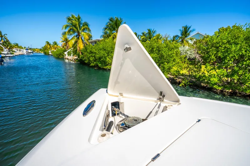  Yacht Photos Pics 2016 Intrepid 400 Center Console boat on a scenic waterway with lush greenery.