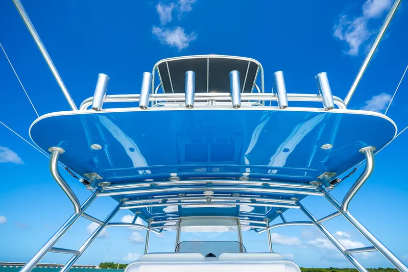  Yacht Photos Pics 2016 Intrepid 400 Center Console boat with sleek blue canopy against clear sky.