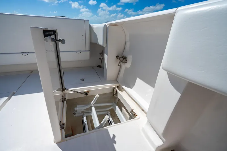  Yacht Photos Pics 2016 Intrepid 400 Center Console boat storage compartment under clear blue sky.