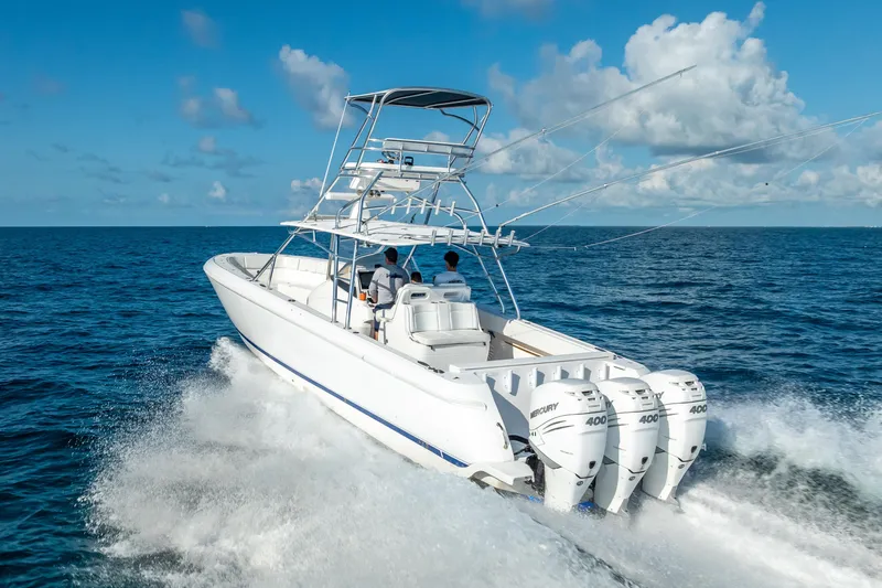  Yacht Photos Pics 2016 Intrepid 400 Center Console boat cruising on open ocean with triple Mercury engines.
