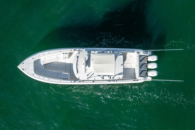  Yacht Photos Pics Aerial view of 2016 Intrepid 400 Center Console boat cruising on green water.